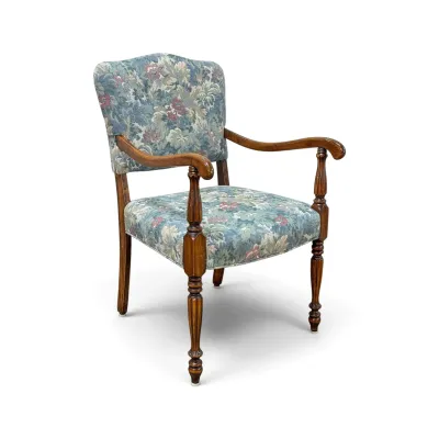 Sale Photo Thumbnail #205: Vintage wooden armchair featuring turned legs and arm supports, upholstered in a blue and green floral tapestry fabric.