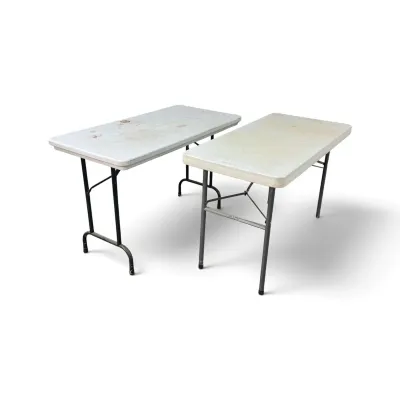 Sale Photo Thumbnail #211: Two rectangular plastic folding tables with metal legs, showing signs of wear and surface staining.