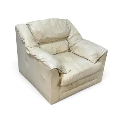 Sale Photo Thumbnail #150: Vintage cream-colored leather armchair featuring a plush, overstuffed design with integrated pillow-top armrests and back cushions, showing some wear and creasing consistent with age.
