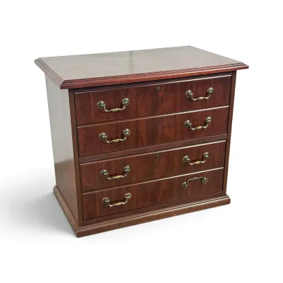 Sale Photo Thumbnail #129: Traditional mahogany lateral file cabinet disguised as a four-drawer chest, featuring brass bail handles and a lockable top drawer.