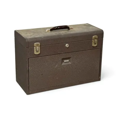Sale Photo Thumbnail #255: Vintage brown metal machinist tool chest with a textured finish, top carrying handle, and dual latches.