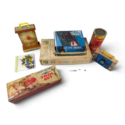 Sale Photo Thumbnail #24: Collection of vintage mid-century toys and games, including a Handy Andy Tool Set, a Pyro Gulf Star Tuna Clipper model kit, a Hit and Missile game, a Fisher-Price musical clock, and a Crosman BB canister.