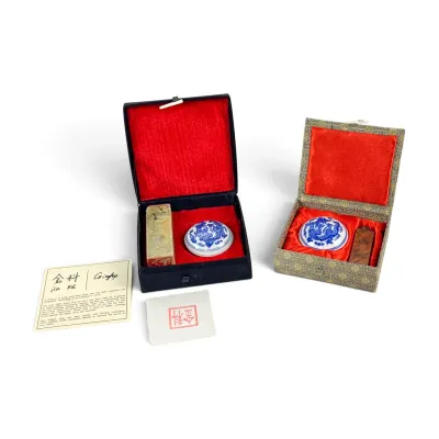 Sale Photo Thumbnail #42: Two Chinese stone seal chop sets, each containing a carved stone seal and a blue and white porcelain ink paste container, presented in silk-lined presentation boxes.