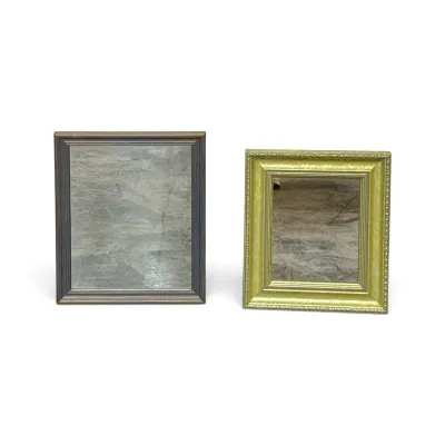 Sale Photo Thumbnail #324: Two vintage tabletop mirrors, featuring one with a dark wood frame and another with a gilded, ornate frame.