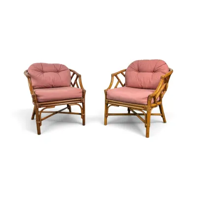 Sale Photo Thumbnail #70: Pair of vintage mid-century rattan armchairs with cross-braced bases and dusty pink tufted cushions.