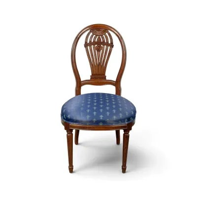Sale Photo Thumbnail #132: Hepplewhite-style mahogany side chair featuring a carved shield back with a central urn motif and a blue patterned upholstered seat.