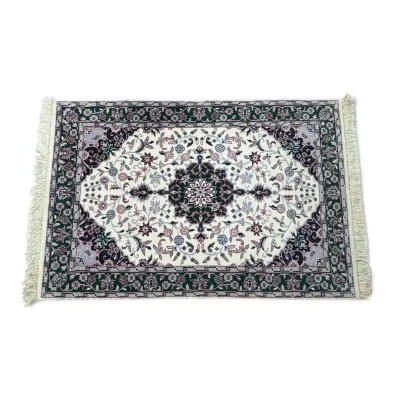 Sale Photo Thumbnail #292: Small Persian-style area rug featuring an intricate floral medallion design in shades of green, purple, and cream with fringed edges.