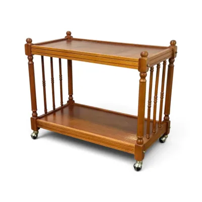 Sale Photo Thumbnail #143: Vintage two-tier wooden rolling cart featuring turned spindle sides, finial accents, and metal casters.