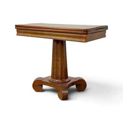 Sale Photo Thumbnail #266: Antique Empire-style mahogany card table featuring a swivel fold-over top, a fluted pedestal column, and a four-legged scroll base.