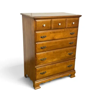 Sale Photo Thumbnail #98: Vintage maple tallboy dresser featuring three small top drawers with white ceramic knobs and four larger drawers with brass batwing pulls.