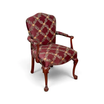 Sale Photo Thumbnail #307: Chippendale-style armchair featuring burgundy upholstery with a gold and green botanical trellis pattern, carved mahogany frame, and ball-and-claw feet.