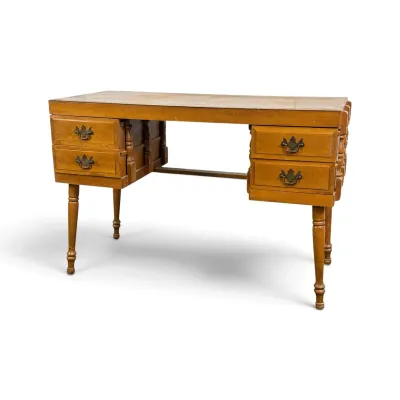 Sale Photo Thumbnail #56: Vintage maple double-pedestal desk featuring four drawers with brass batwing pulls and turned legs, showing some surface wear.