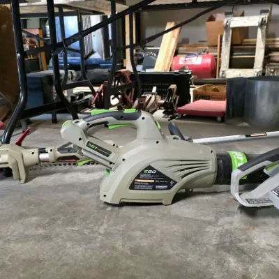Sale Photo Thumbnail #39: Assorted EGO Power+ 56V cordless outdoor power tools, including a leaf blower and hedge trimmer, showing light wear from use.