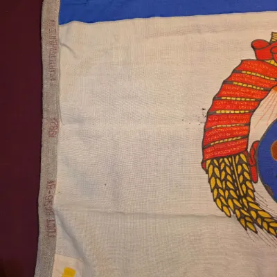 Sale Photo Thumbnail #27: Vintage Soviet-era flag featuring a printed emblem on a white and blue background, with a canvas header stamped with the year 1982.