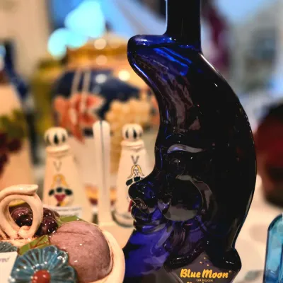 Cobalt blue glass crescent moon-shaped wine bottle from Bridgeview Vineyards Blue Moon Chardonnay.