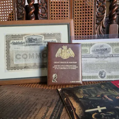 Collection of vintage ephemera including a framed Studebaker stock certificate, an International Mercantile Marine stock certificate, a...