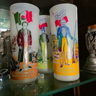 Set of frosted vintage glass highball tumblers featuring printed historical Texas Revolution figures and flags.