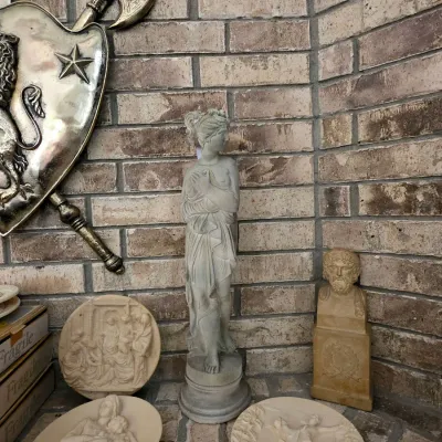 Classical-style decor collection including a full-length draped female statue, a small bust on a pedestal, three decorative relief...