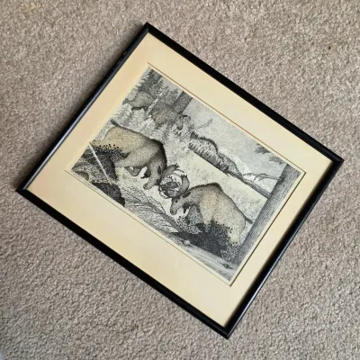Framed black-and-white wildlife print depicting sparring bull moose in a wilderness landscape, signed Forrest Pearson in the corner.