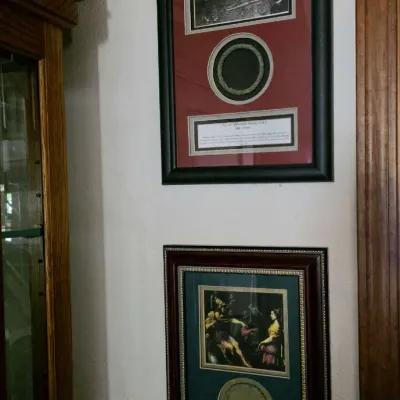 Two framed shadow box displays featuring replica ancient artifact bracelets, pictures, and informational plaques, mounted on a wall.