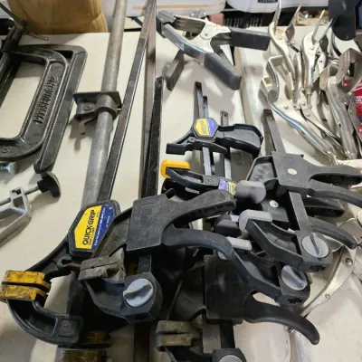 Sale Photo Thumbnail #36: Assortment of woodworking clamps, including Irwin Quick-Grip bar clamps, a Pittsburgh C-clamp, and various spring and locking clamps.