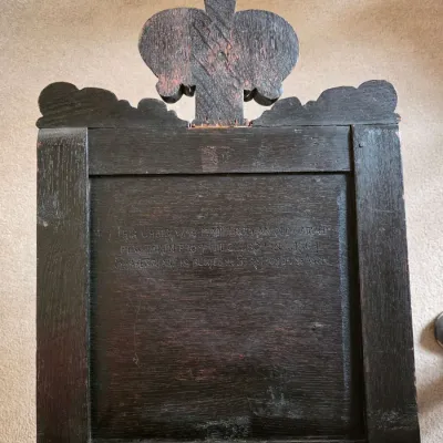 Sale Photo Thumbnail #13: Antique dark oak chair back featuring a carved fleur-de-lis finial and an engraved inscription stating it was made from an old carved pew from the church where Shakespeare is buried in Stratford-upon-Avon.