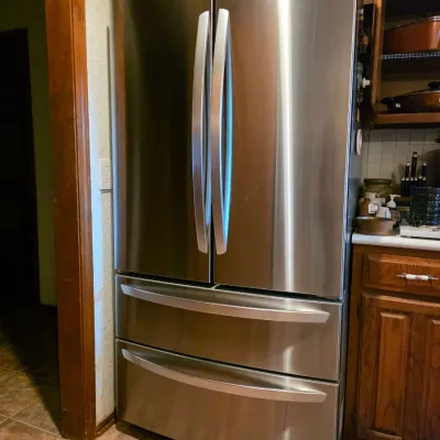 Modern LG stainless steel four-door French door refrigerator with bottom freezer drawers.