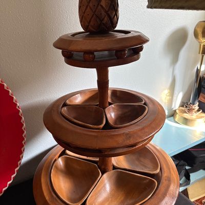 Sale Photo Thumbnail #260: Vintage mid-century monkey pod wood three-tiered lazy Susan server, featuring a carved pineapple finial and removable individual serving dishes.
