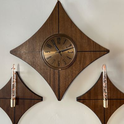 Sale Photo Thumbnail #111: Mid-century modern Elgin diamond-shaped wall clock with matching candle sconces, featuring walnut wood grain and brass accents.