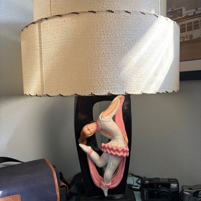 Sale Photo Thumbnail #267: Mid-century modern chalkware table lamp featuring a ballerina figure in a pink tutu, paired with a two-tier fiberglass whipstitched shade.