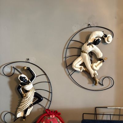 Sale Photo Thumbnail #182: Pair of mid-century modern chalkware wall plaques featuring a dancing couple in white and gold attire, mounted on black wire frames.