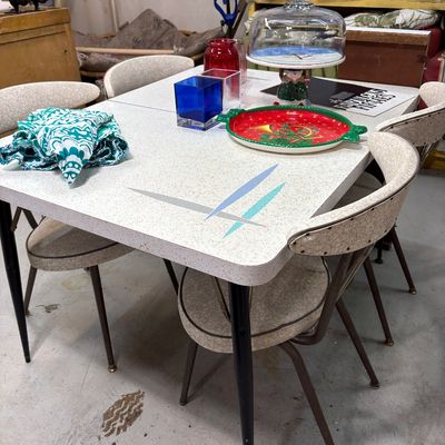 Sale Photo Thumbnail #422: Mid-century modern Formica dining table with a boomerang-style pattern, paired with four matching vinyl-upholstered chairs.