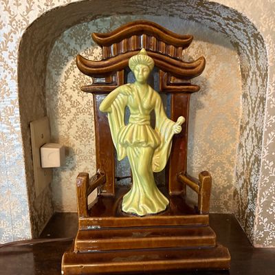 Mid-century ceramic TV lamp featuring a green-glazed Asian female figure standing before a brown-glazed pagoda structure.