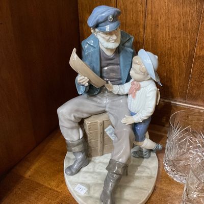 Lladro porcelain figurine titled "The Sailor's Story" (or "A Sailor's Tale"), depicting an old sailor...