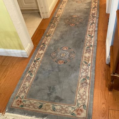Chinese Art Deco style wool runner rug in dusty blue with floral medallions and a cream border, featuring fringed ends.