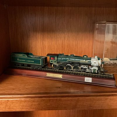 Southern Crescent Limited model steam locomotive and tender, displayed on a wooden track base with a brass nameplate.