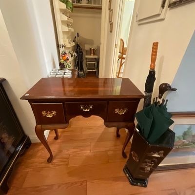 Queen Anne style cherry wood writing desk or vanity with cabriole legs and brass batwing pulls.