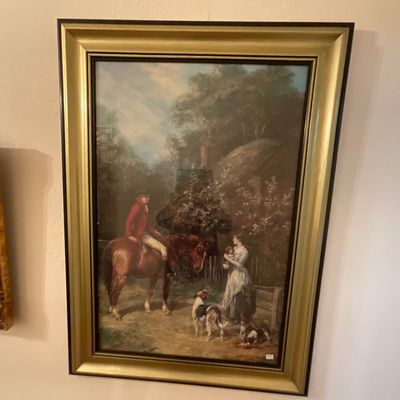 Framed print depicting a classic English equestrian scene with a rider on horseback, a woman, and hunting dogs, housed in a wide...