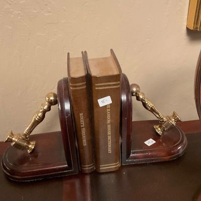 Pair of vintage wooden bookends featuring polished brass gavels, holding a copy of Roget's Thesaurus and The Random House Dictionary.
