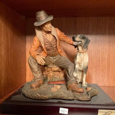 Vintage Giuseppe Armani style resin figurine depicting a hunter in a hat and jacket seated next to his hunting dog, mounted on a dark...