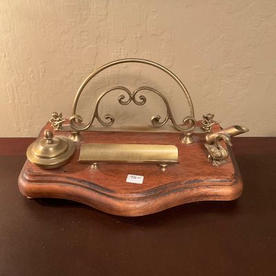 Vintage brass and wood desk organizer featuring a letter holder, inkwell, pen tray, and decorative brass swan and cherub figurines.