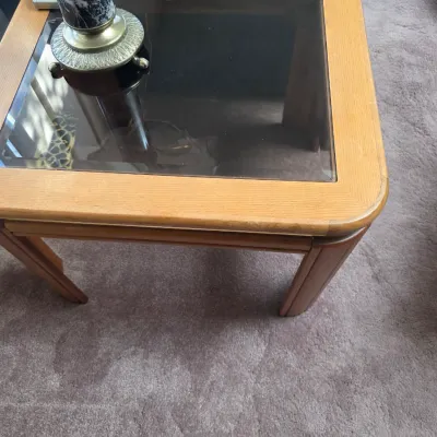 Sale Photo Thumbnail #28: Vintage oak end table featuring a smoked glass insert top and rounded corners, circa 1970s or 1980s.