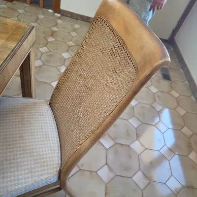 Sale Photo Thumbnail #46: Vintage dining chair featuring a curved cane backrest, light wood frame, and a neutral patterned fabric seat cushion.