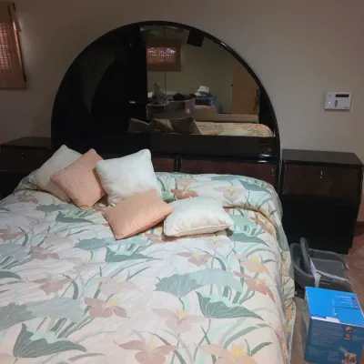 Sale Photo Thumbnail #124: Postmodern 1980s black laminate queen-size platform bed featuring a large half-moon mirrored headboard and integrated matching nightstands.