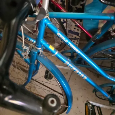 Sale Photo Thumbnail #94: Vintage blue Schwinn World Tourist bicycle showing some wear and dust from storage.