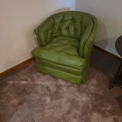 Sale Photo Thumbnail #118: Vintage mid-century tufted barrel chair upholstered in avocado green vinyl.