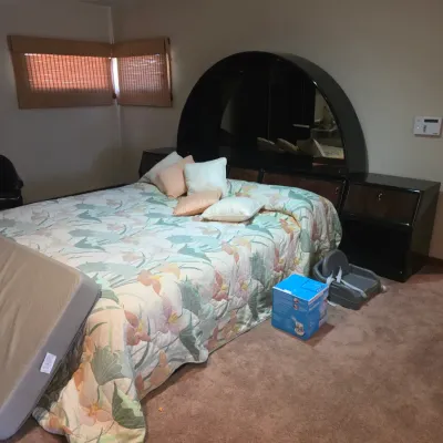 Sale Photo Thumbnail #115: Vintage 1980s laminate bedroom set featuring a large arched headboard with integrated mirrors and matching bedside nightstands.