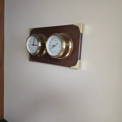 Sale Photo Thumbnail #21: Vintage Chelsea nautical clock and barometer set, mounted on a mahogany plaque with brass corner brackets.