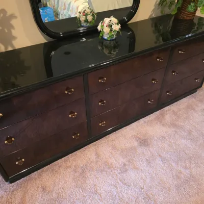 Sale Photo Thumbnail #113: Postmodern-style nine-drawer dresser featuring a high-gloss black laminate top and trim, dark burl wood drawer fronts, and brass hardware.