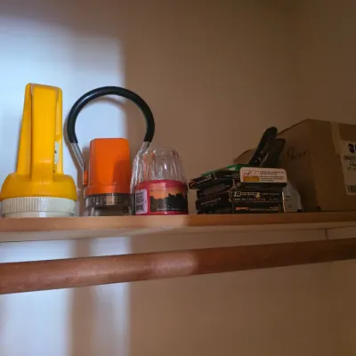 Sale Photo Thumbnail #7: Assorted vintage flashlights, lanterns, and office supplies, including Arrow staples, arranged on a wooden closet shelf.